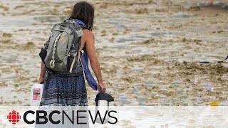 Burning Man festival 70000 attendees stranded and one dead after rain and flooding [upl. by Ruosnam210]