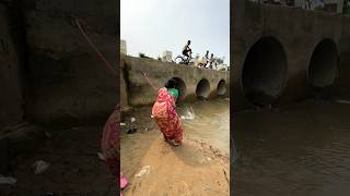 A woman catches fish from a large dam with a hook  amazing fishing in the canal  fishing shorts [upl. by Wardlaw]