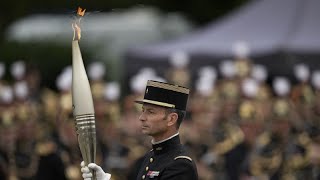 The Olympic torch lights up Frances Bastille Day military parade [upl. by Lenroc]