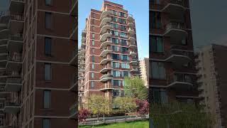 View of trees bushes green grass people and blocks of flats with balconies [upl. by Rather]