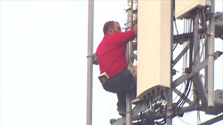 Man impersonating TMobile worker climbs onto cell tower in Miami [upl. by Eneleuqcaj753]