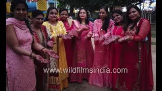 Indian women show off their hands with henna tattoos for Karva Chauth [upl. by Hagood]