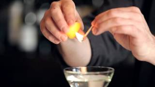 How to Flame an Orange Peel  DrinkSkool Bar Techniques [upl. by Nawoj]