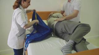 Transferring from a bed to a chair featuring the Application of a Universal Sling and A 150F Folding [upl. by Salhcin941]