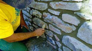 HOW TO BUILD NATURAL STONE WALL RETAINING ROCK BOULDERS DETAIL MASONRY ADVICE TUTORIAL CONSTRUCTION [upl. by Ynnaj235]