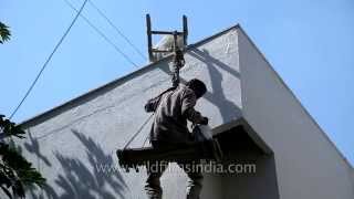 Indian workers paint a building sitting on a makeshift wooden swinglike plank [upl. by Pauly350]