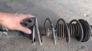 Car front strut removal Shock absorber damper replacement [upl. by Llerdnad483]