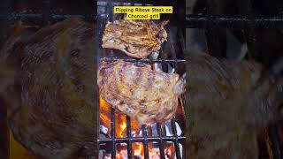 Flipping Ribeye Steak on a Charcoal Grill flipping ribeyesteak grilling shortsfeed shorts [upl. by Hsepid]