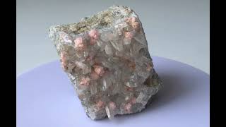 Rhodochrosite spherulites on clear Quartz crystal druse 2 [upl. by Inavihs]