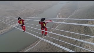 Workers Maintain Worlds Highestvoltage Power Line across Yellow River [upl. by Mars88]