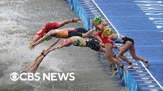 Olympic triathletes swim in Seine after water quality delay [upl. by Timothea]