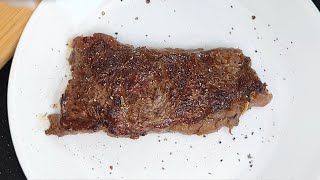 Cooking a bison New York strip steak in a castiron skillet cooking steak recipe [upl. by Aicxela]