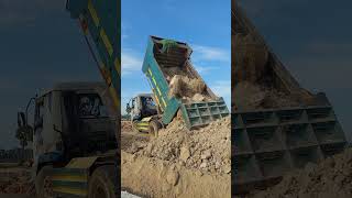 Dump truck is dumping the soil in action bulldozer dumptruck excavator [upl. by Blanch]