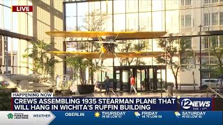 Stearman plane hoisted up to hang inside Ruffin building in downtown Wichita [upl. by Aikemit]