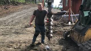 Digging fence post holes with skidsteer auger [upl. by Ezitram]