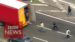 Moment Calais migrants jumped onboard lorries  BBC News [upl. by Ahsinwad527]