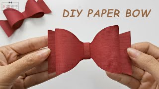 How to make a paper bow out of gift wrapping paper  Origami bow tie tutorial [upl. by Randolf]