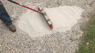 brushing CHEAP concrete onto a gravel driveway adding strength and resilience [upl. by Edlihtam]