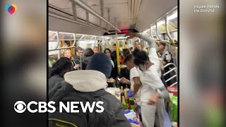 NYC subway passengers serve full Thanksgiving meal during commute [upl. by Aremmat]