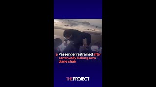 Passenger restrained after continually kicking own plane chair [upl. by Essila]