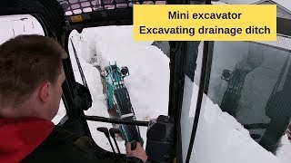 Kobelco SK17 excavating drainage ditch in snow [upl. by Teeter]