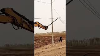 Wire laying process from ground onto a pole with an excavator [upl. by Ewald]