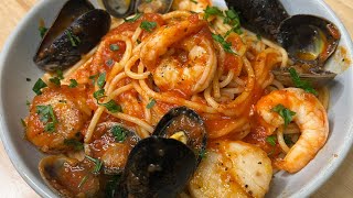 Italian Seafood Pasta with Scallops Calamari Shrimp Clams and Mussels in a savory tomato sauce [upl. by Micco312]